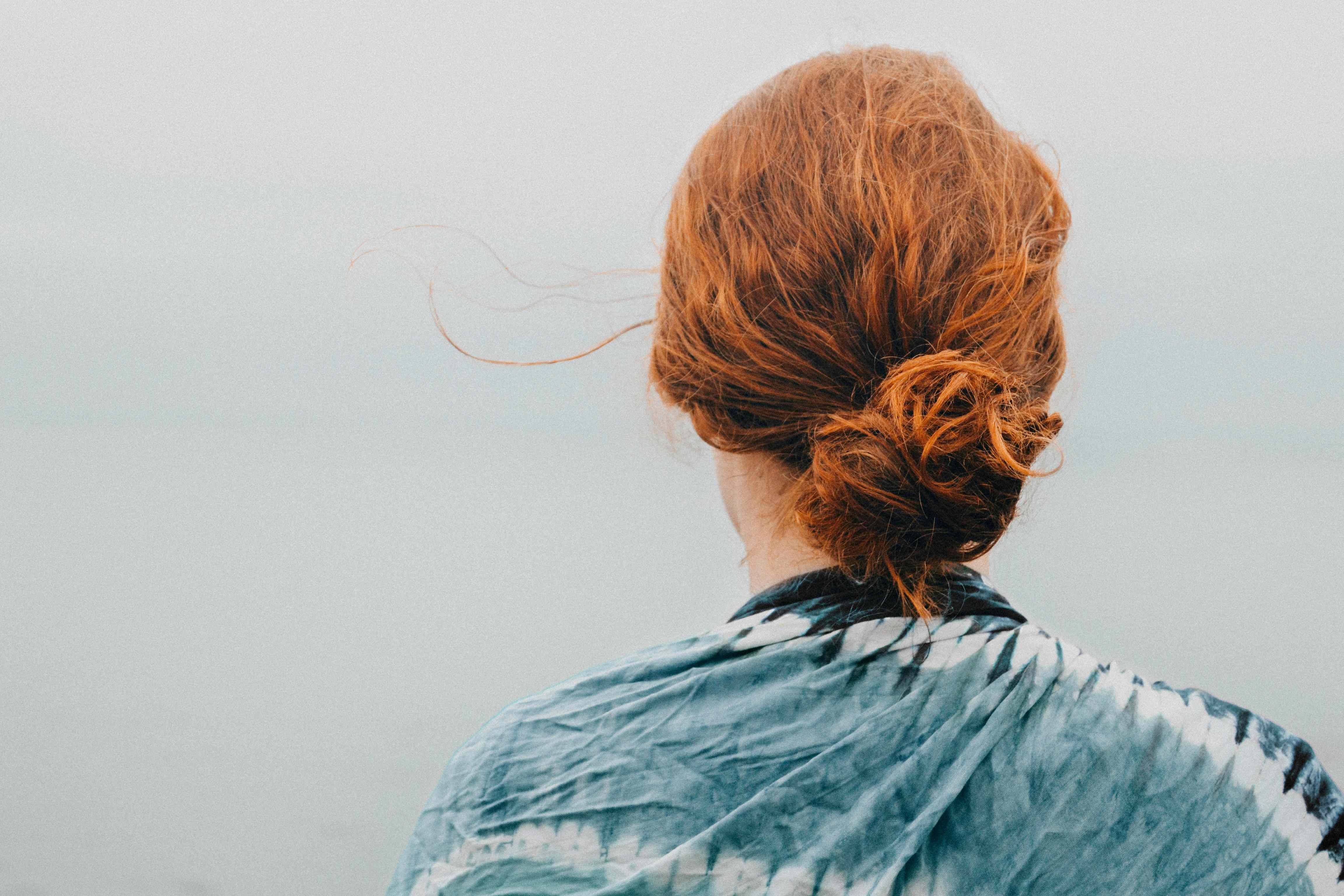 Young person from behind stormy