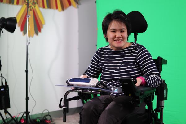 Lisa, who is a wheelchair user and uses a communication device
