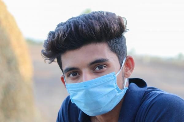 A young man wearing a mask