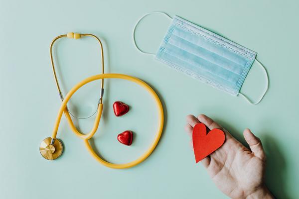 A stethoscope with a heart and mask