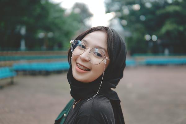 A young person smiling at the camera.