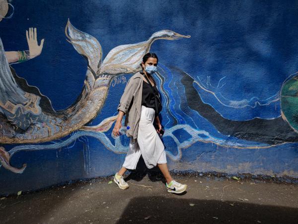 Lady walking on street with mask