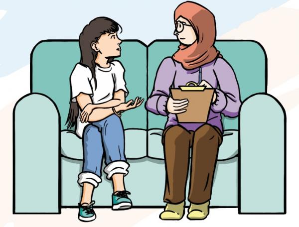 A young person talking to a worker holding a clipboard, wearing a headscarf